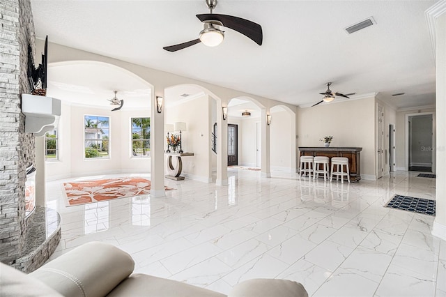 4353 Dewey Dr, New Port Richey, FL 34652 - living room with a ceiling fan, arched walkways, marble finish flooring, and baseboards