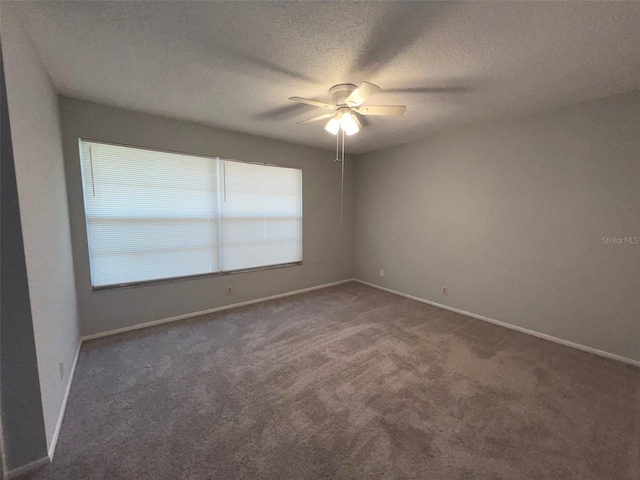 14667 Pine Glen Crk Unit 14667, Lutz, FL 33559 - unfurnished room with a ceiling fan, dark colored carpet, baseboards, and a textured ceiling