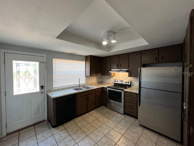 14667 Pine Glen Crk Unit 14667, Lutz, FL 33559 - kitchen featuring appliances with stainless steel finishes, a tray ceiling, under cabinet range hood, light countertops, and a textured ceiling