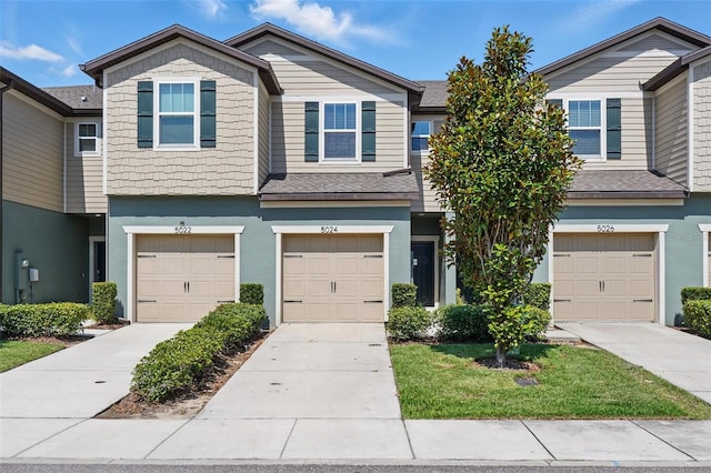 5024 Sylvester Loop, Tampa, FL 33610 - multi unit property with a garage, stucco siding, and driveway