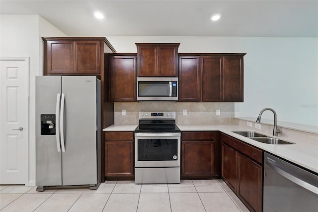 5024 Sylvester Loop, Tampa, FL 33610 - kitchen featuring stainless steel appliances, a sink, light countertops, decorative backsplash, and dark brown cabinetry