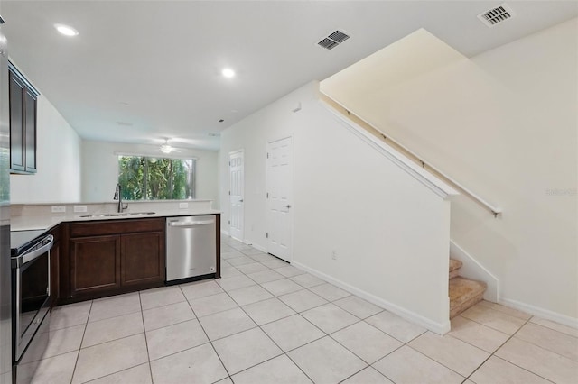 5024 Sylvester Loop, Tampa, FL 33610 - kitchen with stainless steel appliances, a sink, light tile patterned floors, light countertops, and recessed lighting