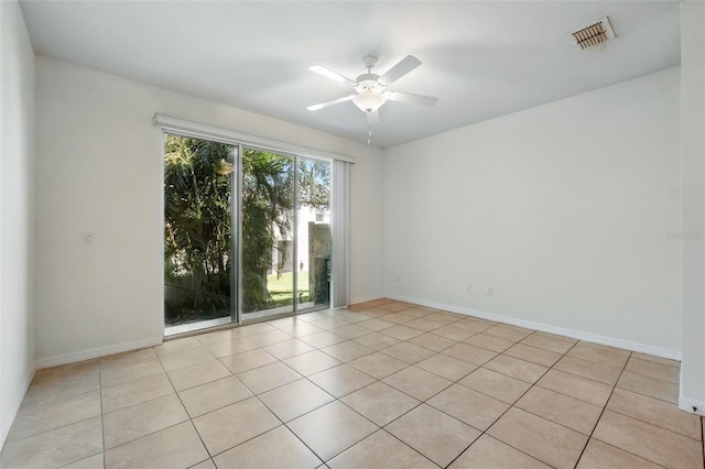 5024 Sylvester Loop, Tampa, FL 33610 - spare room featuring light tile patterned flooring, a ceiling fan, and baseboards