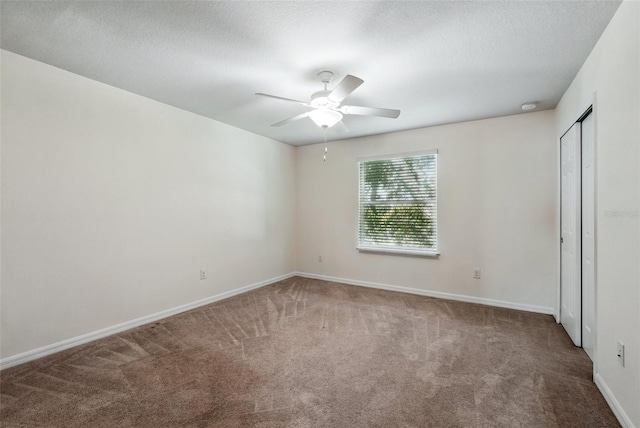 5024 Sylvester Loop, Tampa, FL 33610 - unfurnished bedroom featuring carpet floors, baseboards, a ceiling fan, and a textured ceiling