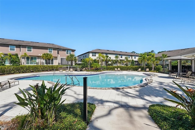5024 Sylvester Loop, Tampa, FL 33610 - community pool featuring a patio and a residential view
