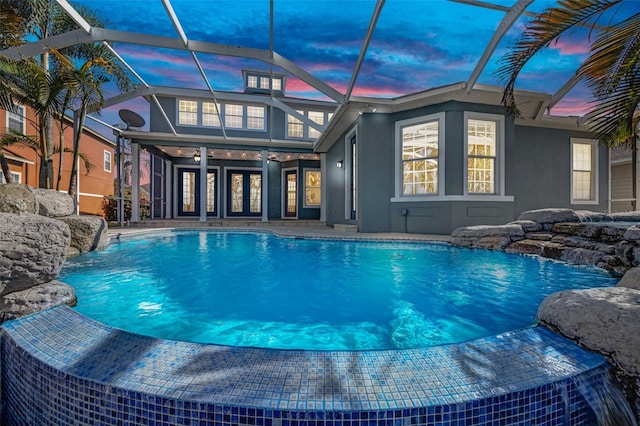 5225 Brighton Shore Dr, Apollo Beach, FL 33572 - pool at dusk with an outdoor pool, a ceiling fan, and glass enclosure