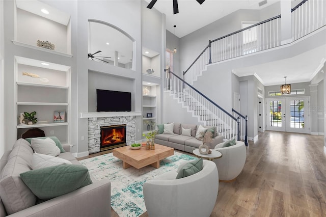 5225 Brighton Shore Dr, Apollo Beach, FL 33572 - living room with ceiling fan, a high ceiling, built in features, stairs, and baseboards