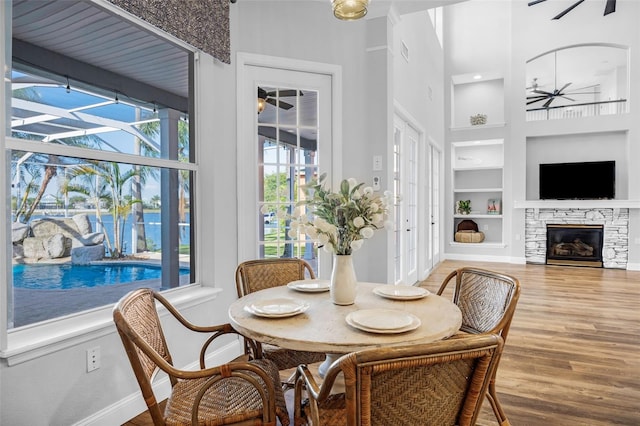 5225 Brighton Shore Dr, Apollo Beach, FL 33572 - dining space with built in features, baseboards, a high ceiling, wood finished floors, and a ceiling fan