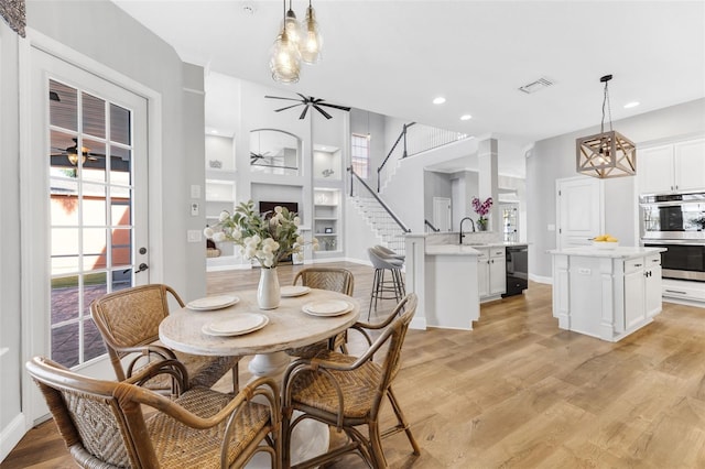 5225 Brighton Shore Dr, Apollo Beach, FL 33572 - dining room featuring ceiling fan, recessed lighting, light wood finished floors, built in shelves, and baseboards