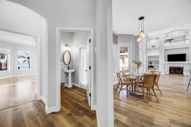 5225 Brighton Shore Dr, Apollo Beach, FL 33572 - corridor with built in shelves, healthy amount of natural light, wood finished floors, and baseboards