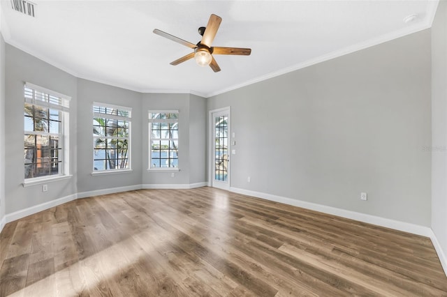 5225 Brighton Shore Dr, Apollo Beach, FL 33572 - spare room featuring plenty of natural light, wood finished floors, crown molding, baseboards, and a ceiling fan