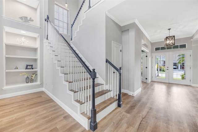 5225 Brighton Shore Dr, Apollo Beach, FL 33572 - foyer entrance with stairs, wood finished floors, baseboards, ornamental molding, and a chandelier