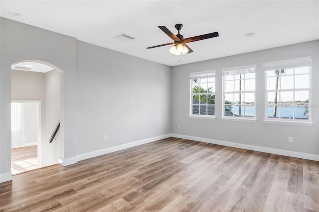 5225 Brighton Shore Dr, Apollo Beach, FL 33572 - unfurnished room featuring arched walkways, wood finished floors, and baseboards