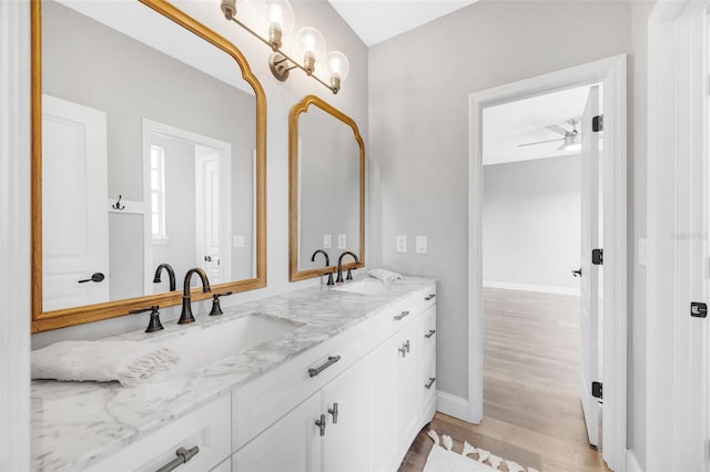 5225 Brighton Shore Dr, Apollo Beach, FL 33572 - full bathroom with wood finished floors, double vanity, ceiling fan, and baseboards