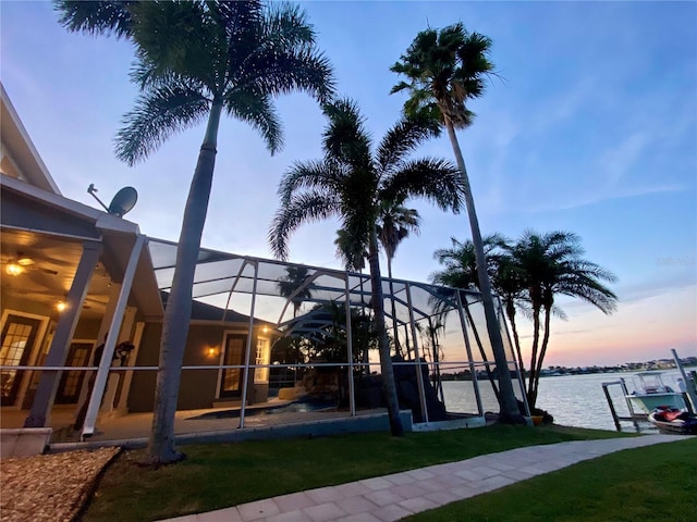 5225 Brighton Shore Dr, Apollo Beach, FL 33572 - yard at dusk featuring a water view and a lanai