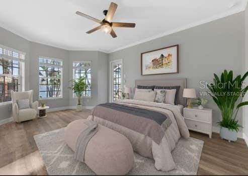 5225 Brighton Shore Dr, Apollo Beach, FL 33572 - bedroom featuring baseboards, wood finished floors, crown molding, and a ceiling fan