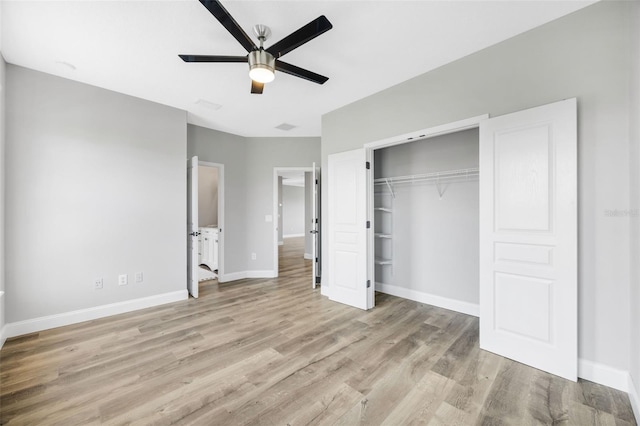 5225 Brighton Shore Dr, Apollo Beach, FL 33572 - unfurnished bedroom featuring wood finished floors, baseboards, a closet, and a ceiling fan