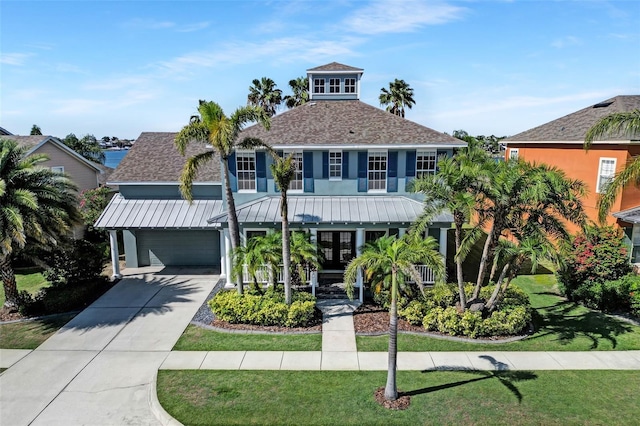 5225 Brighton Shore Dr, Apollo Beach, FL 33572 - coastal home featuring an attached garage, a shingled roof, a front yard, and driveway