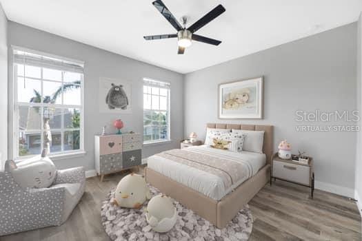 5225 Brighton Shore Dr, Apollo Beach, FL 33572 - bedroom with baseboards, wood finished floors, and ceiling fan