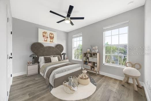 5225 Brighton Shore Dr, Apollo Beach, FL 33572 - bedroom with wood finished floors, baseboards, and ceiling fan