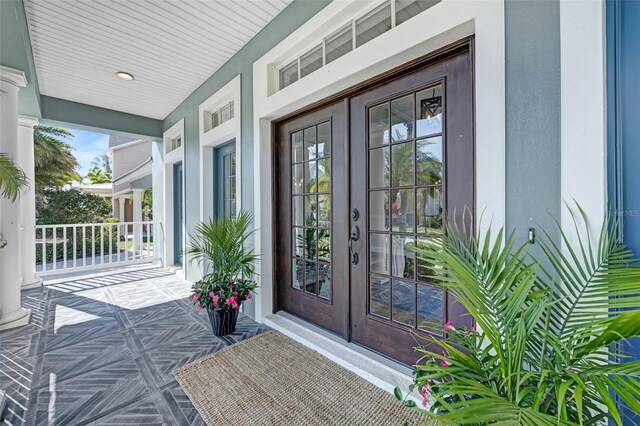 5225 Brighton Shore Dr, Apollo Beach, FL 33572 - doorway to property featuring a porch, french doors, and stucco siding
