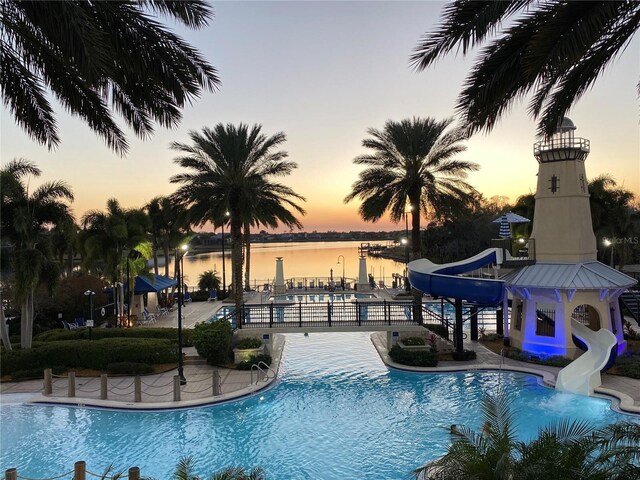 5225 Brighton Shore Dr, Apollo Beach, FL 33572 - community pool with a water slide, a water view, and a patio
