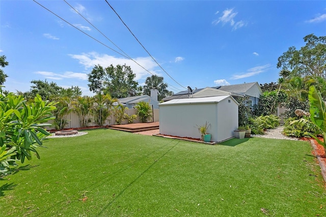 6183 5th Ave S, Saint Petersburg, FL 33707 - view of yard featuring a fire pit and a wooden deck