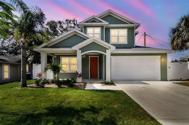 511 Roanoke St, Dunedin, FL 34698 - view of front facade with concrete driveway, covered porch, and an attached garage