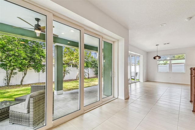 511 Roanoke St, Dunedin, FL 34698 - doorway with a ceiling fan, light tile patterned floors, and baseboards