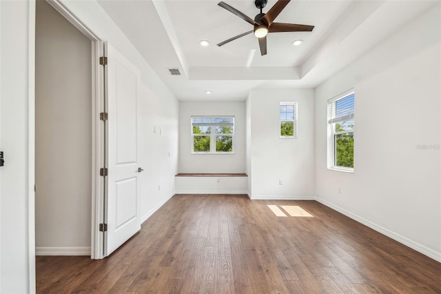 511 Roanoke St, Dunedin, FL 34698 - empty room featuring hardwood / wood-style floors, healthy amount of natural light, ceiling fan, a tray ceiling, and recessed lighting