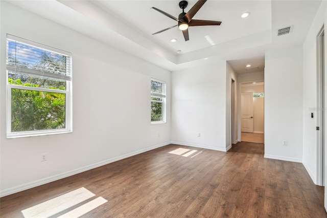 511 Roanoke St, Dunedin, FL 34698 - unfurnished room with dark wood-style flooring, baseboards, a tray ceiling, ceiling fan, and recessed lighting