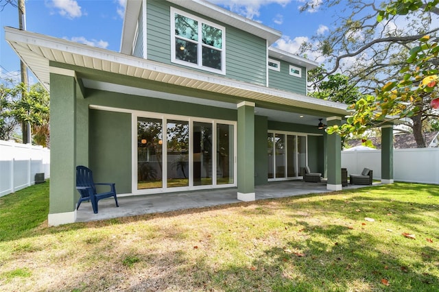 511 Roanoke St, Dunedin, FL 34698 - back of property with a ceiling fan, a patio, and stucco siding