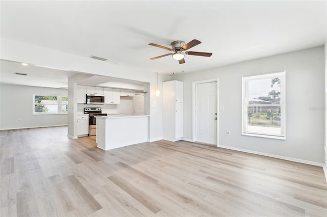 315 Dorchester Dr, Venice, FL 34293 - unfurnished living room featuring a ceiling fan, light wood-type flooring, and baseboards