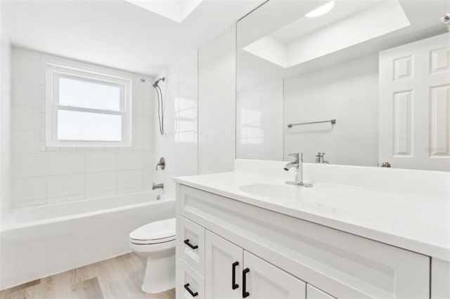 315 Dorchester Dr, Venice, FL 34293 - bathroom featuring toilet, vanity, wood finished floors, and washtub / shower combination