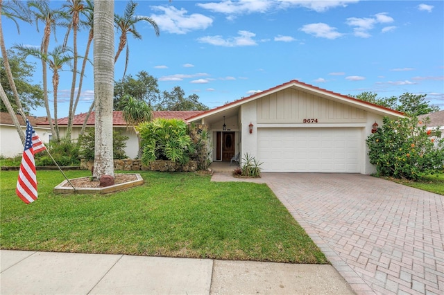 9674 104th Ave, Largo, FL 33773 - single story home featuring a garage, decorative driveway, a front lawn, and stucco siding