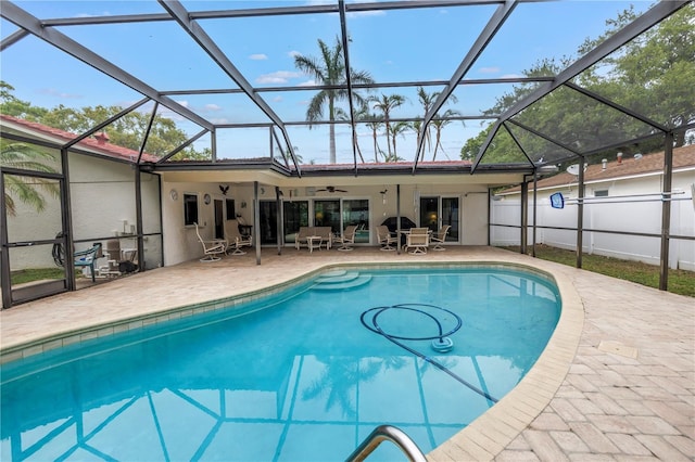 9674 104th Ave, Largo, FL 33773 - swimming pool featuring a ceiling fan, a patio, and glass enclosure
