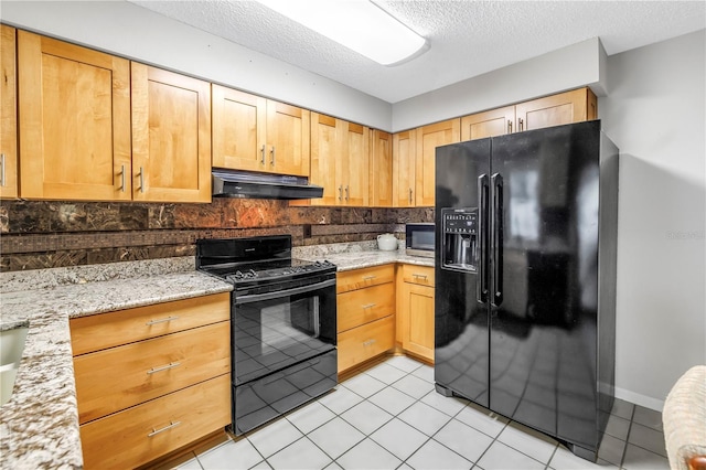9674 104th Ave, Largo, FL 33773 - kitchen featuring black appliances, under cabinet range hood, decorative backsplash, a textured ceiling, and light stone countertops