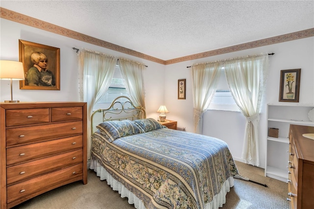 9674 104th Ave, Largo, FL 33773 - bedroom featuring light colored carpet, multiple windows, and a textured ceiling