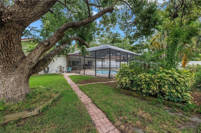 9674 104th Ave, Largo, FL 33773 - view of grassy yard featuring an outdoor pool, a patio area, and a lanai