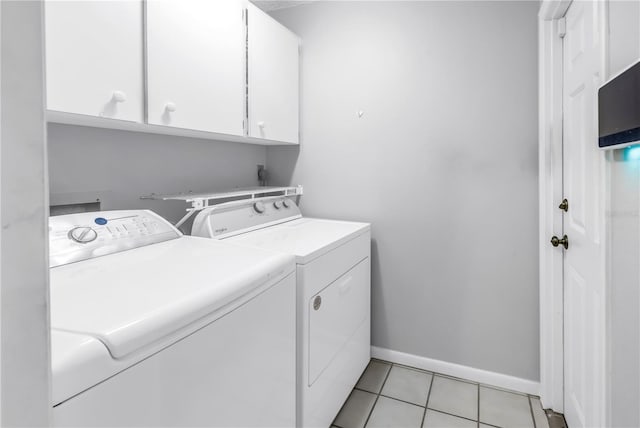 9674 104th Ave, Largo, FL 33773 - washroom with washing machine and dryer, cabinet space, baseboards, and light tile patterned flooring