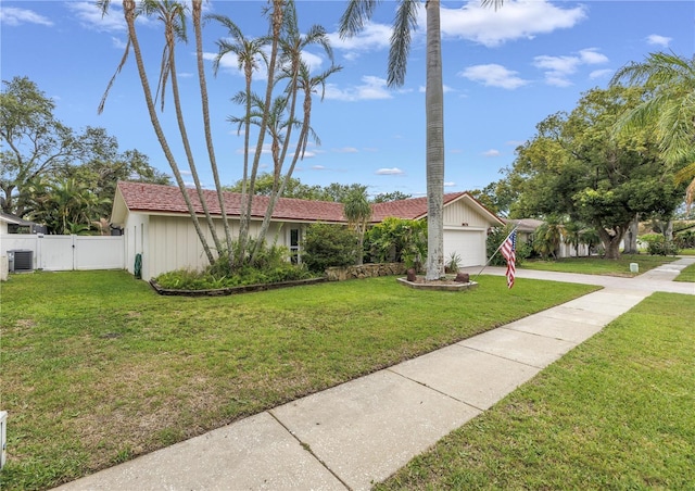 9674 104th Ave, Largo, FL 33773 - view of front of house with driveway, a garage, central AC unit, and a gate
