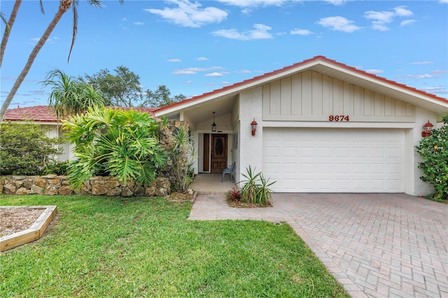 9674 104th Ave, Largo, FL 33773 - single story home featuring an attached garage, decorative driveway, a front lawn, and stucco siding