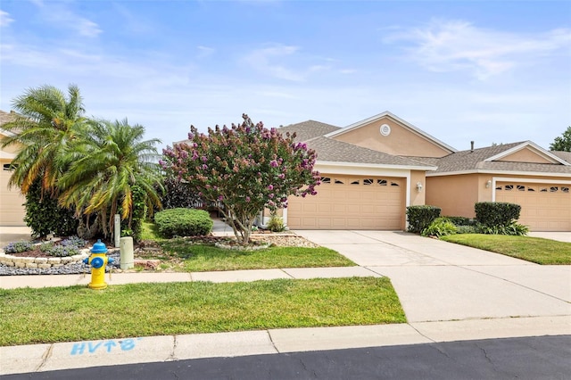 31108 Whitlock Dr, Wesley Chapel, FL 33543 - view of front facade featuring a garage, stucco siding, driveway, and a shingled roof