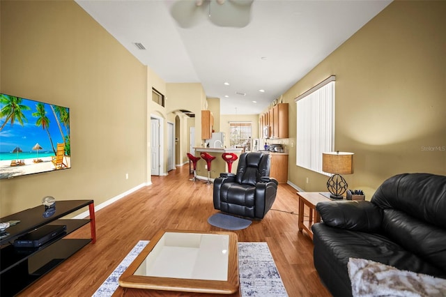 31108 Whitlock Dr, Wesley Chapel, FL 33543 - living area featuring a ceiling fan, wood finished floors, baseboards, and arched walkways