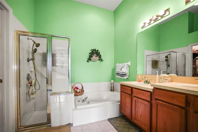 31108 Whitlock Dr, Wesley Chapel, FL 33543 - bathroom with a stall shower, double vanity, a garden tub, and tile patterned floors