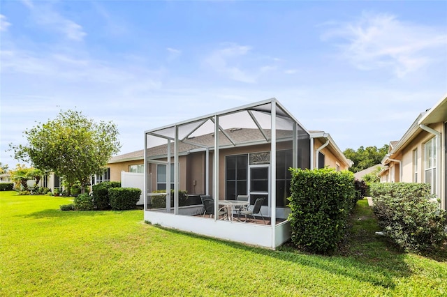 31108 Whitlock Dr, Wesley Chapel, FL 33543 - back of house with a lawn, glass enclosure, stucco siding, and a patio