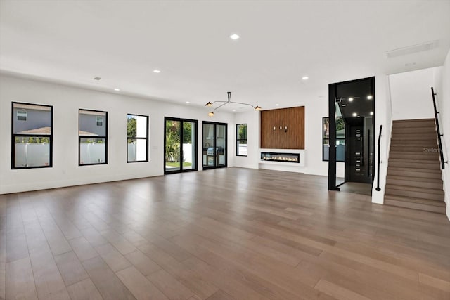 908 W Fribley St, Tampa, FL 33603 - unfurnished living room featuring recessed lighting, stairway, wood finished floors, and a fireplace
