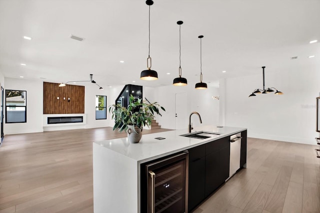 908 W Fribley St, Tampa, FL 33603 - kitchen with a sink, wine cooler, light wood-style floors, light countertops, and recessed lighting