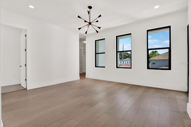 908 W Fribley St, Tampa, FL 33603 - unfurnished room with a chandelier, wood finished floors, and baseboards
