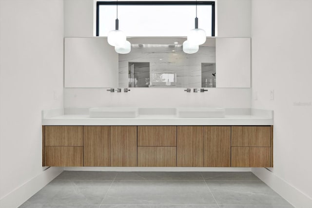 908 W Fribley St, Tampa, FL 33603 - bathroom with double vanity, a marble finish shower, marble look tiles, and baseboards